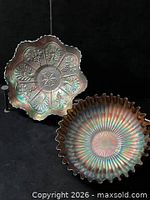 Both carnival glass bowls, full view showing designs and edges