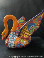 Left side view of ceramic swan planter showing multicolor Talavera patterns