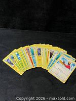 Fan spread of 24 yellow-border Pokémon cards