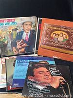 Close-up of several record sleeves showing artists and wear