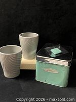 Coffee canister with two gray mugs group view