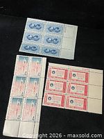 Three plate blocks displayed together: Atoms for Peace (8), U.S.–Japan (6), In God We Trust (6)