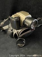 Camera on top of leather case with filter visible