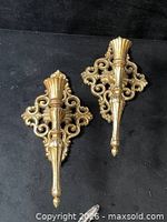 Front view showing both ornate brass sconces