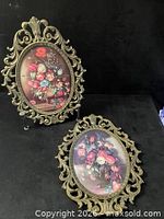 Both ornate oval metal frames front view