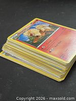 Stack of unsleeved Pokémon cards, top card Arcanine visible