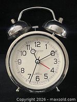 Front view of Sterling & Noble twin bell alarm clock showing dial and bells
