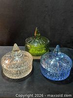 Front view of the three covered dishes showing colours and lids in place