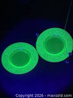 Two uranium glass plates glowing green under blacklight