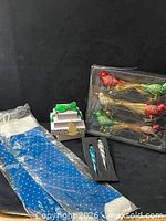 Full lot showing bird ornaments in blister pack, stockings, icicles in foam, gift boxes