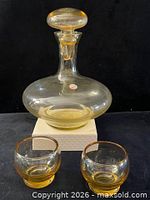 decanter with stopper and two glasses front view