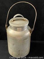 Full view of Mirro aluminum jug with lid and bail handle attached