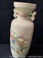 Full view of vase showing painted peacock, floral design and side handles