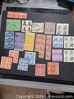Overall view of all stamp blocks and singles on black sheet