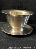Side view of brushed stainless steel compote bowl showing pedestal base and flared bowl