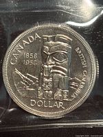 Reverse of 1958 Canada silver dollar showing totem pole design