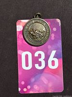 Front view of Royal Life Saving Society medal on numbered card