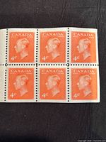 Front view of six connected 4¢ King George VI Canada stamps