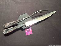 Carving knife and fork front view on black background