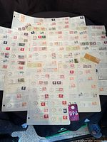 Stack of album pages filled with Canadian stamps on piece