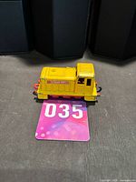 Left side of yellow diecast Shunter locomotive showing D1496-RF and No.5