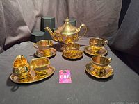 Full set showing teapot, cups with saucers, creamer, sugar bowl on tray