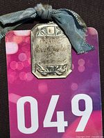 Front view of engraved medallion with ribbon