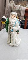 Front view of ceramic Santa Claus holding lantern