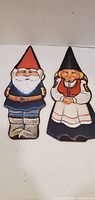 Front view of both wooden gnome figures