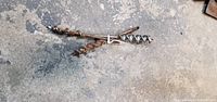 Two antique auger bits on concrete floor