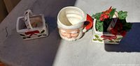 Front view of Santa mug flanked by two baskets
