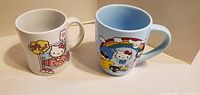 Front view of both Hello Kitty mugs
