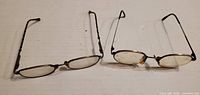Both pairs of eyeglasses side by side showing overall design and size