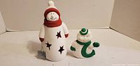 Front view of both ceramic snowmen showing size and paint details