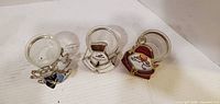 Front view of all three stained glass tealight holders: angel, snowman, Santa