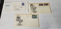 Front view of three first-day covers showing stamps, cachets and postmarks
