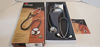 Closed box beside opened box showing stethoscope and accessories