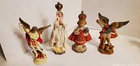 Front view of all four resin figurines showing details and paint
