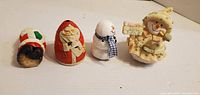 Front view of four small Christmas figurines side by side