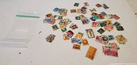 Overview of entire lot of loose stamps and empty zip bag