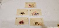Five Marlen Line glassine stamp packets laid out showing logos and contents