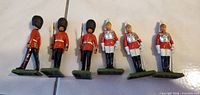 Six Britains plastic guard soldiers standing