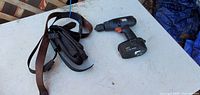 Black & Decker 18V cordless drill and leather tool belt on table