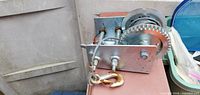 Overall view of boat trailer winch with cable and hook