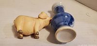 Vase on side showing foot and base, pig figurine lying side