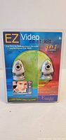 Front view of sealed EZ Video Chat Kit showing two webcams in package