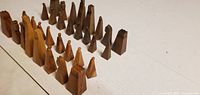 Full set of geometric wooden chess pieces in two tones