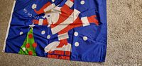 Full view of blue flag with Santa, tree, snow dots and text