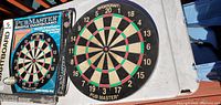 Front view of dartboard beside original box