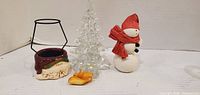 All four items: Santa candle holder, glass tree, snowman, yellow ornament